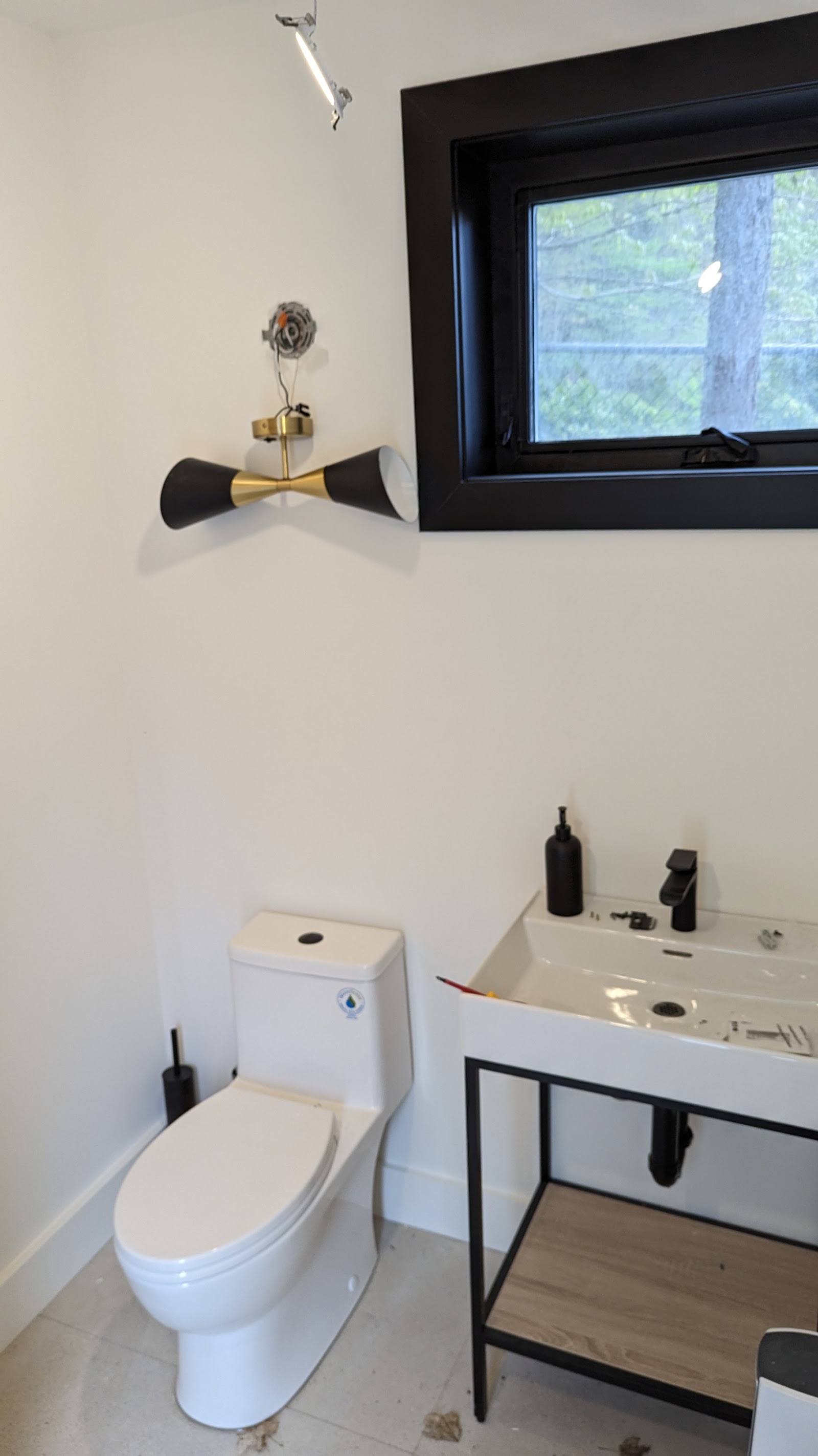 Black window trim and fixture detail in a finished bathroom