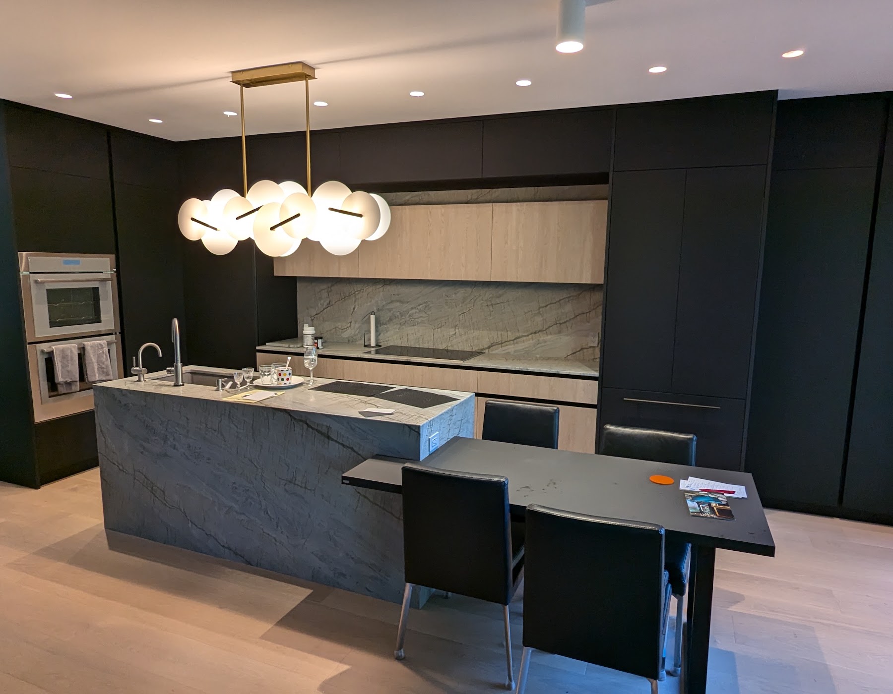Finished dark cabinet kitchen with stone island
